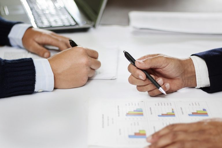 Two people looking at financial figures