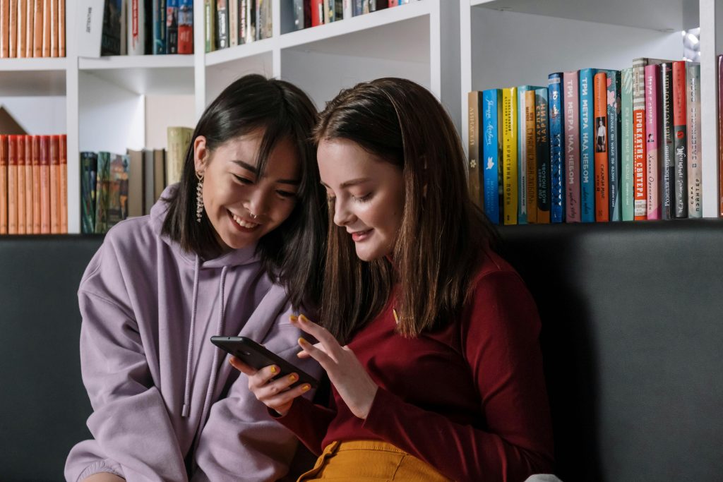 Two people looking at a phone.