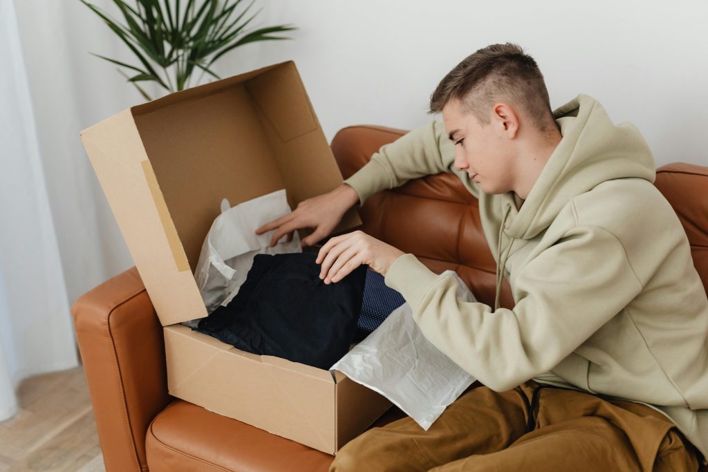 A person looking into a cardboard box.